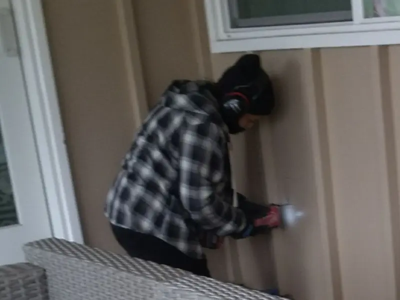 Professional electrician installing an exterior outlet in Mound
