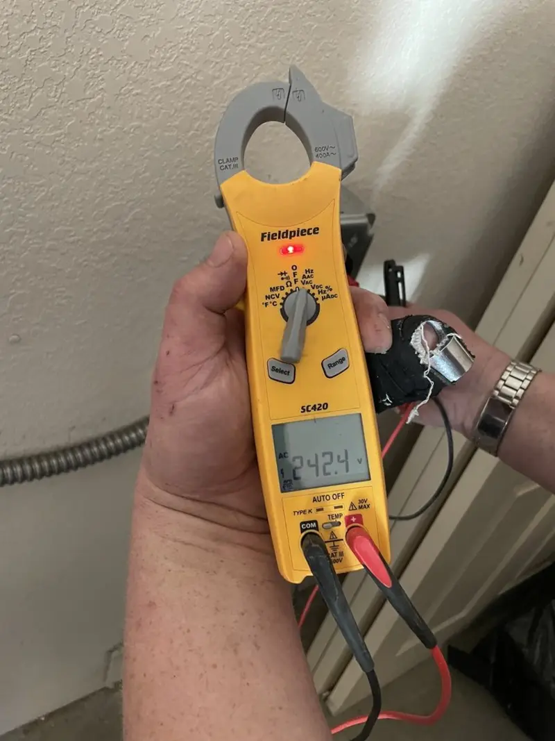 Voltage testing with clamp meter during Outlet Installation in Mound